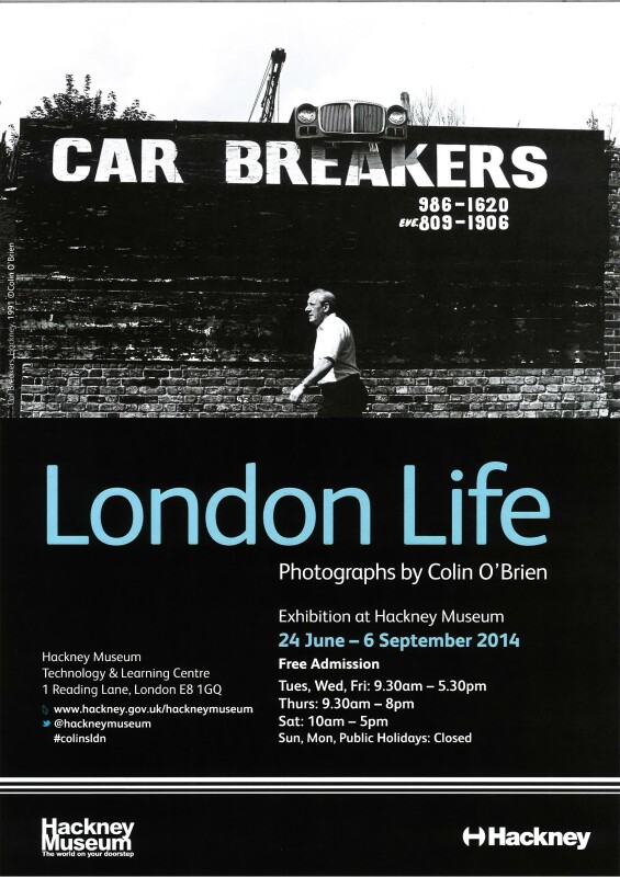 Poster for the exhibition "London Life". Features a black and white photograph by Colin O'Brien showing a man walking past a sign reading "Car Breakers"
