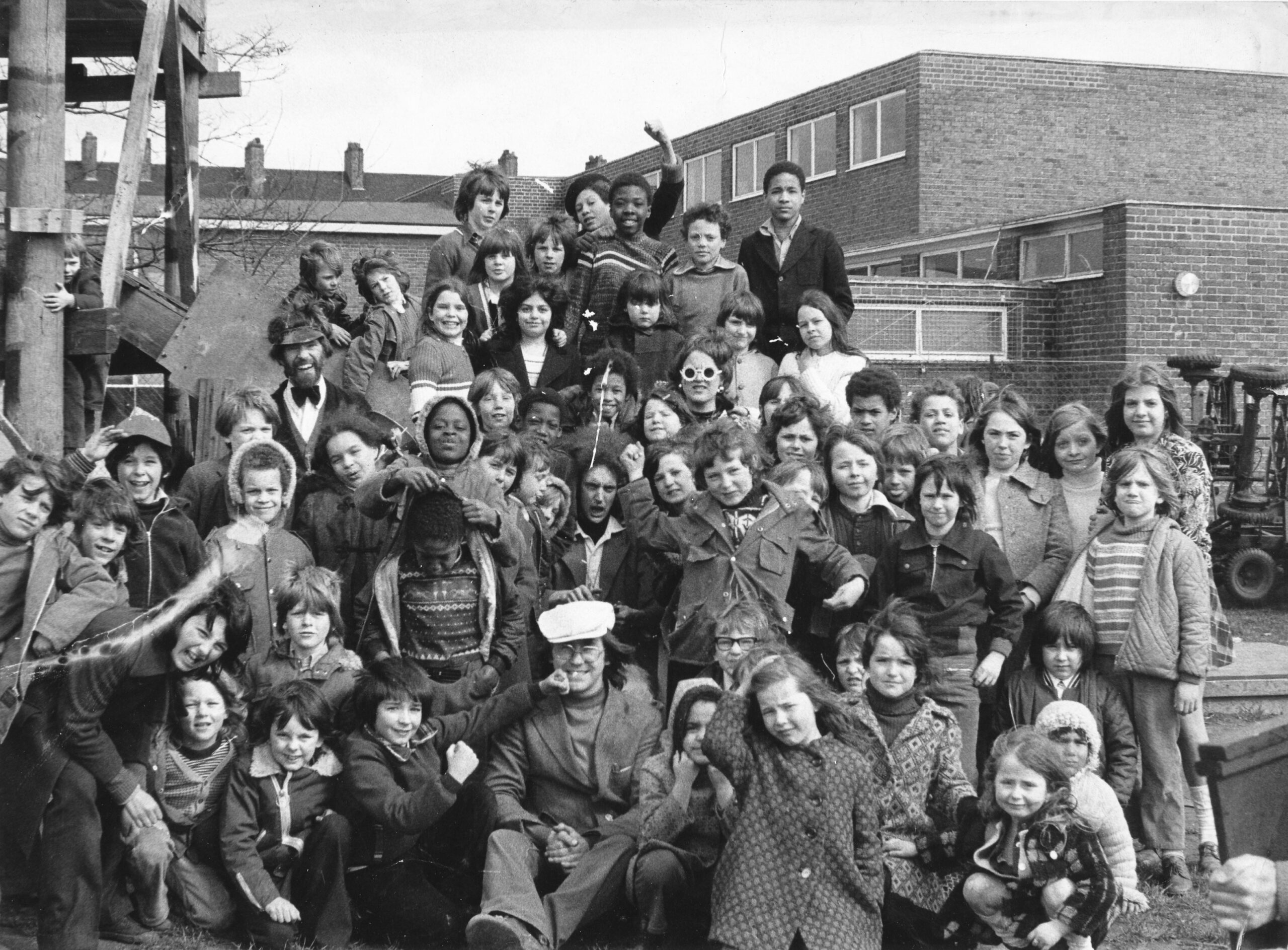 Black and white photo of a group of children at an adventure playground 