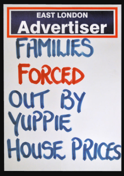 Poster for the East London Advertiser newspaper with a handwritten headline 'Families forced out by yuppie house prices'. The word 'forced' is in red ink and the rest in blue ink.