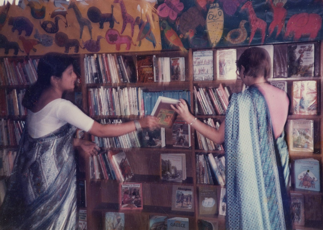 Colour photograph of two women in saris at Goldsmith’s Row Library, Bengali storytelling session, 1984.
