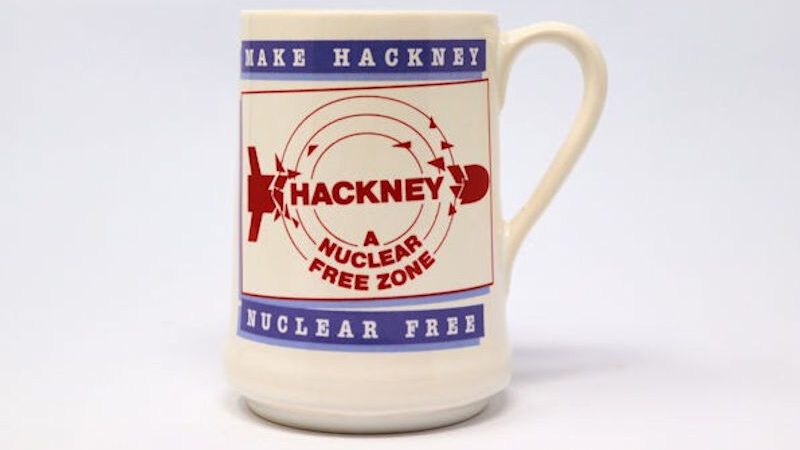 White mug with red and blue graphic of a broken missile. The mug reads “MAKE HACKNEY NUCLEAR FREE”.